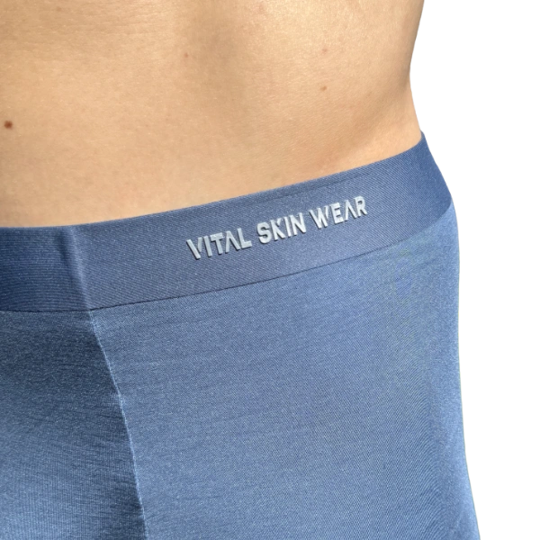 Blue underwear with 'Vital Skin Wear' waistband on a white background